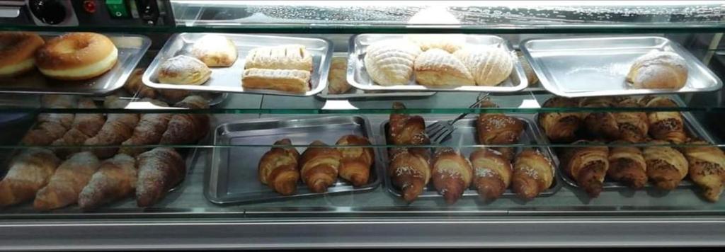 a display case filled with lots of different types of pastries at Sweet Dream in Caserta
