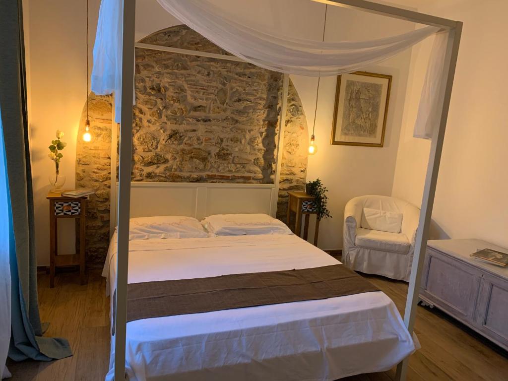a bedroom with a bed with a canopy at Il giardino dei limoni in Suvereto