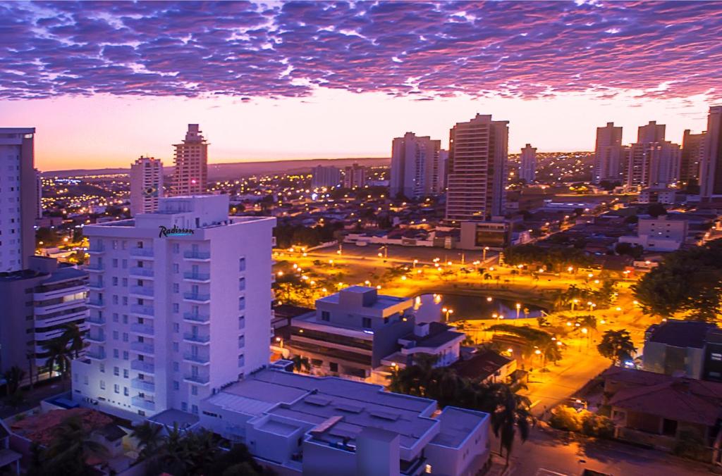 a view of a city at night with lights at Radisson Hotel Anápolis in Anápolis