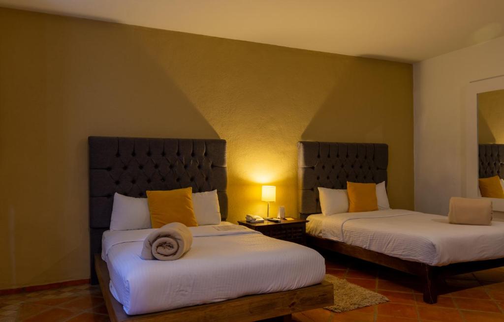 Postel nebo postele na pokoji v ubytování Hotel Hacienda San Cristóbal