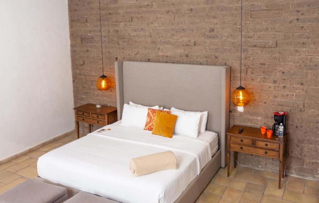 Postel nebo postele na pokoji v ubytování Hotel Hacienda San Cristóbal