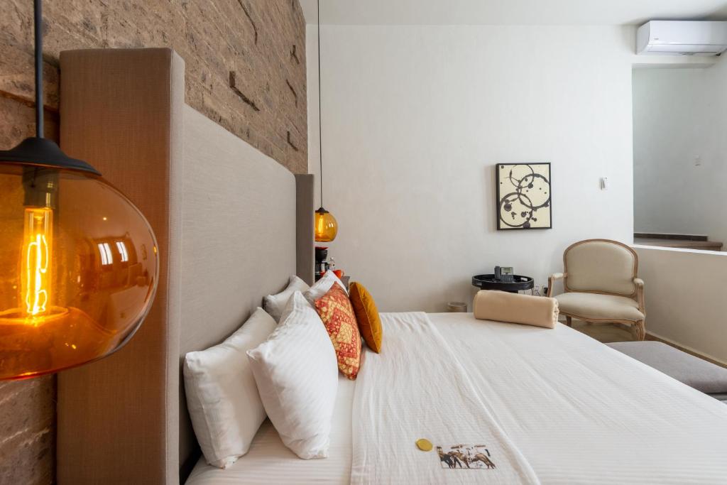 Postel nebo postele na pokoji v ubytování Hotel Hacienda San Cristóbal