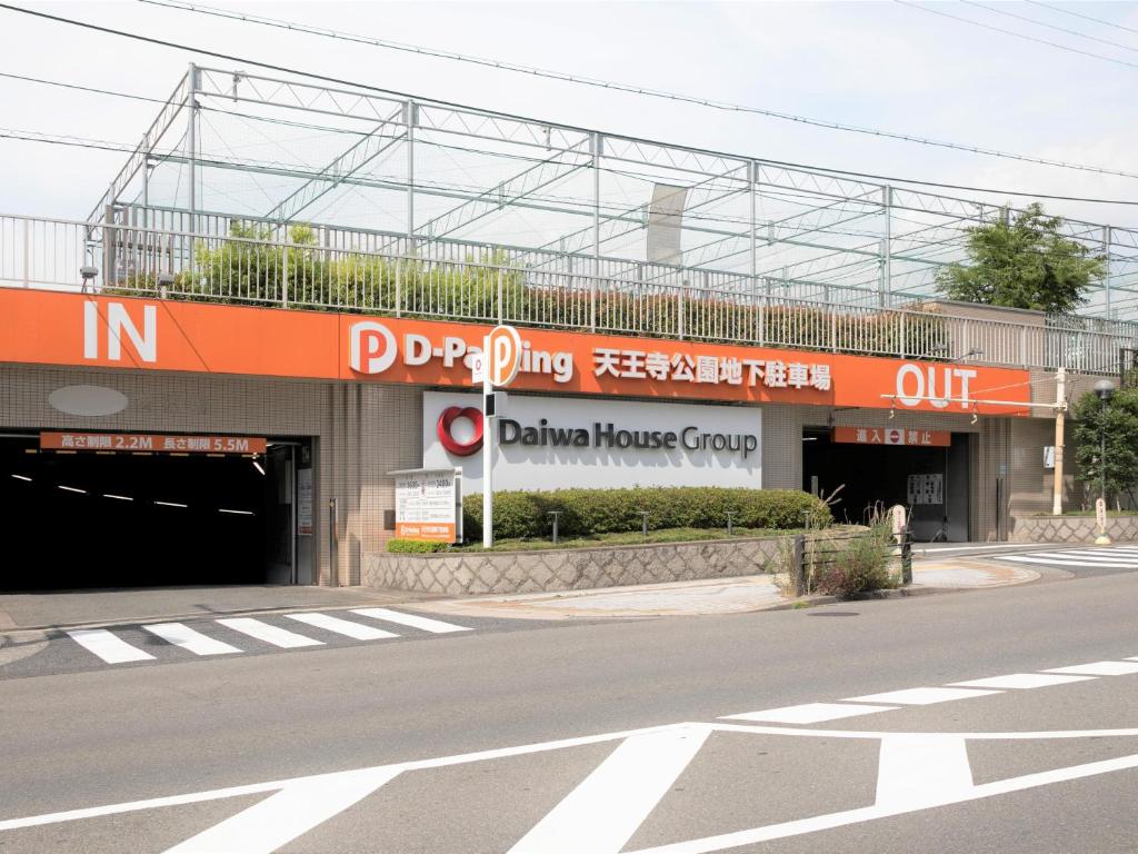 a building with an entrance to a garage housegroup at APA Hotel Tennoji Ekimae in Osaka