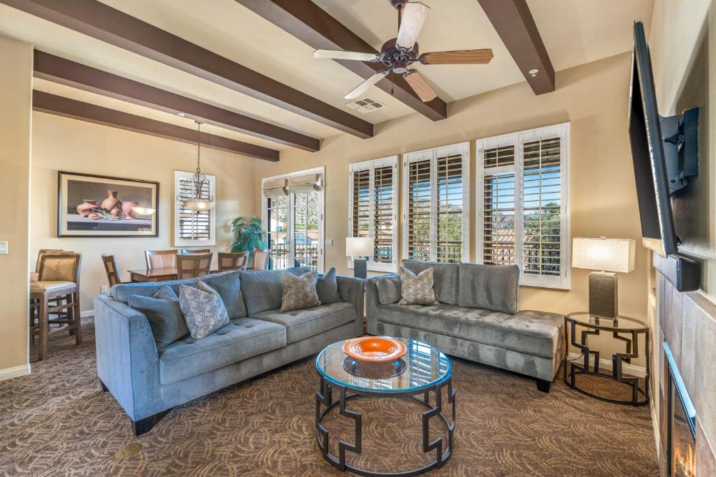 a living room with a couch and a ceiling fan at C48 Lux Villa Near Clubhouse With Mtn Views Condo in La Quinta
