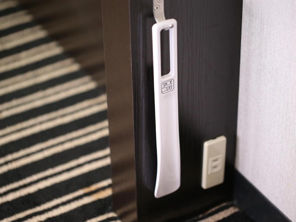 a close up of a door with a white handle at APA Hotel Tennoji Ekimae in Osaka