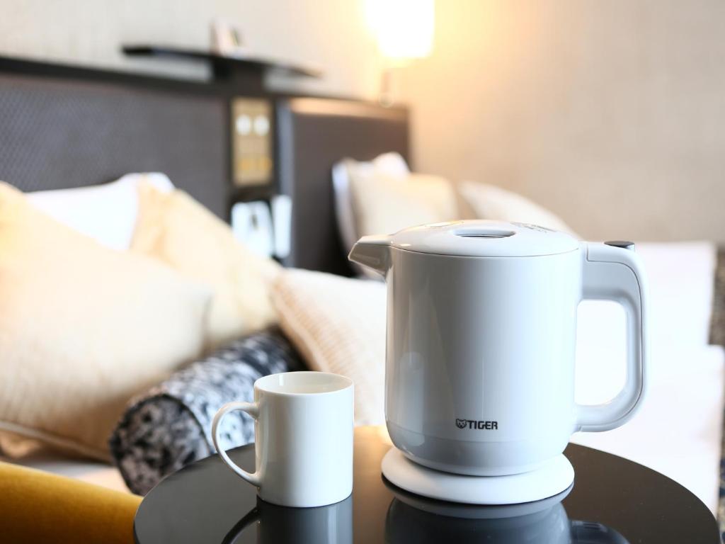 a white blender sitting on a table with a cup at APA Hotel Tennoji Ekimae in Osaka