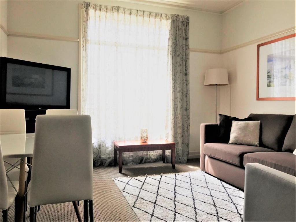 a living room with a couch and a table at Brisbane City Apartments (Central Station) in Brisbane