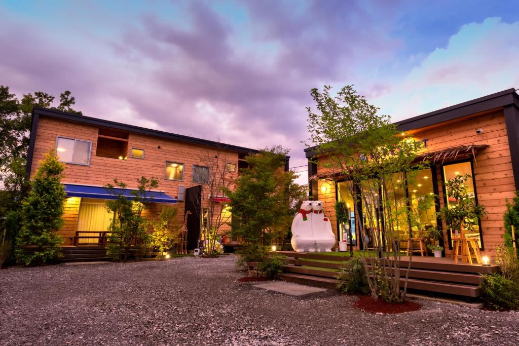 a house with a large glass door on the side of it at Kawaguchiko Villa FJ Resort in Fujikawaguchiko