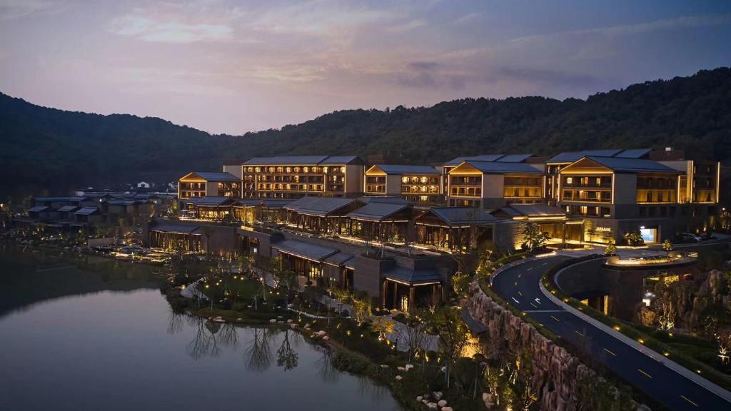 an aerial view of a resort on the water at night at Xianghu Xiaoyao Manor in Xiaoshan