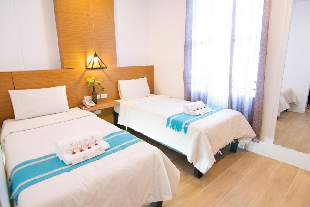 Postel nebo postele na pokoji v ubytování Viven Hotel