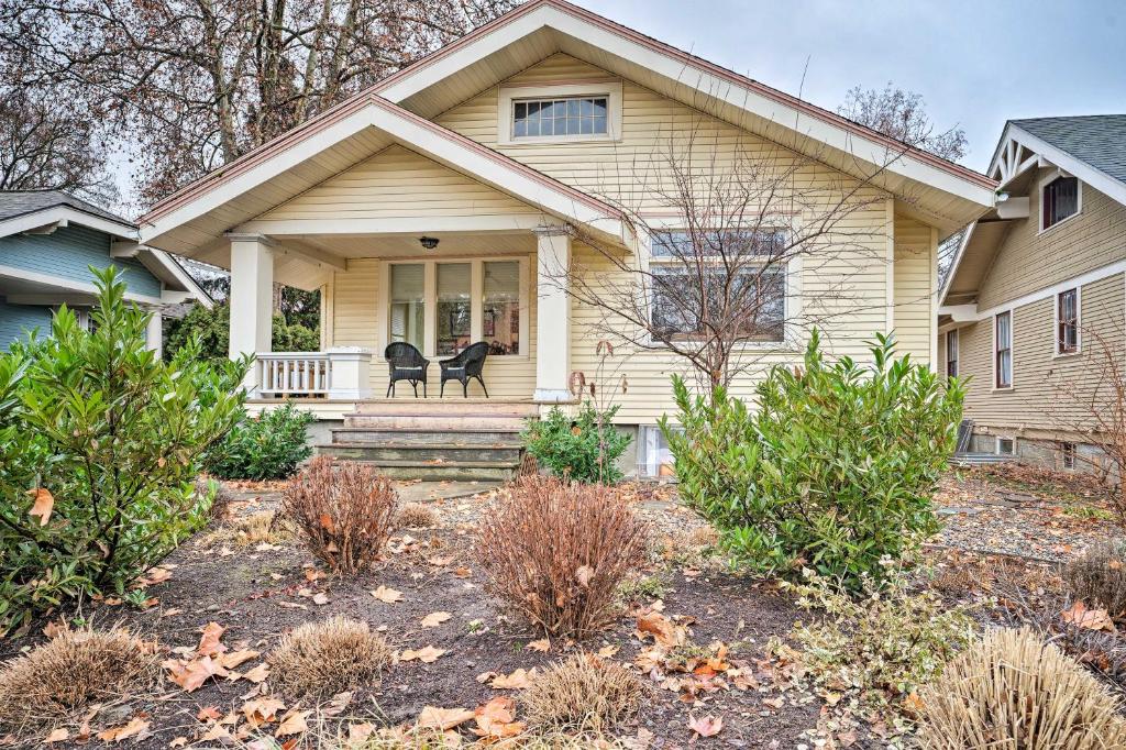 a house with a black dog sitting on the front porch at Peaceful Wine Country Getaway - Walk to Downtown! in Walla Walla