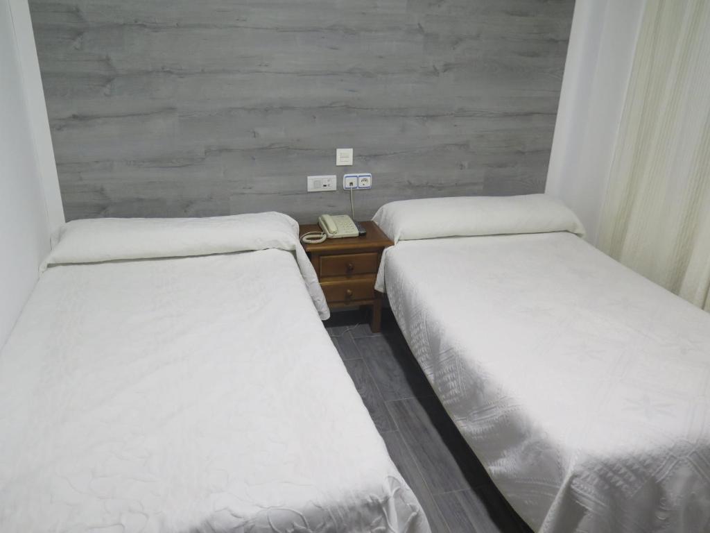 Postel nebo postele na pokoji v ubytování Hotel Restaurante Boabdil