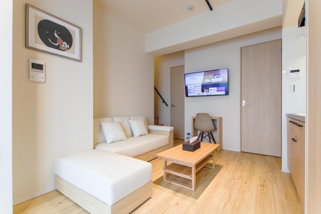 a small living room with a couch and a table at VACATION INN KAMATA I in Tokyo