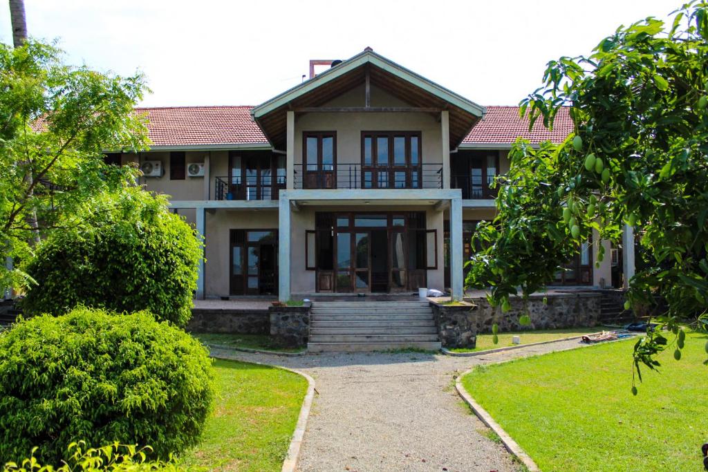 a house with a walkway in front of it at Aayu Lagoon in Negombo