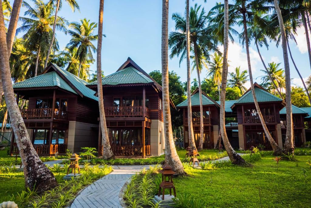 a resort with palm trees in front of it at Sea Shell Resort & Spa, Havelock in Havelock Island