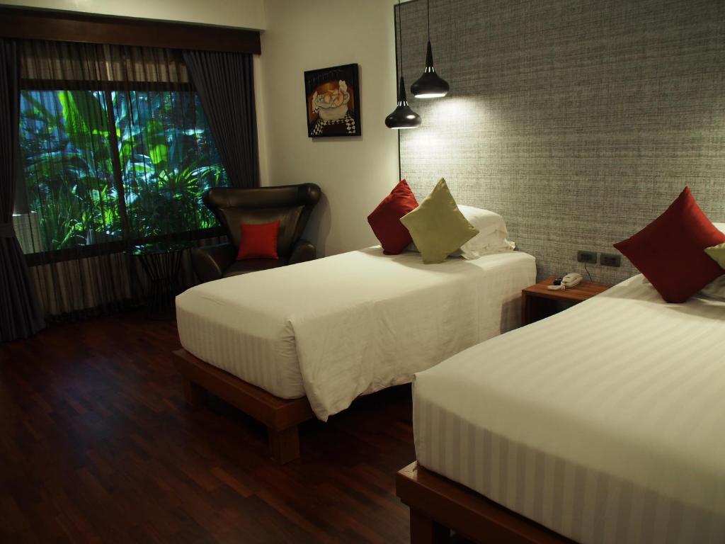 Llit o llits en una habitació de Laluna Hotel And Resort, Chiang Rai