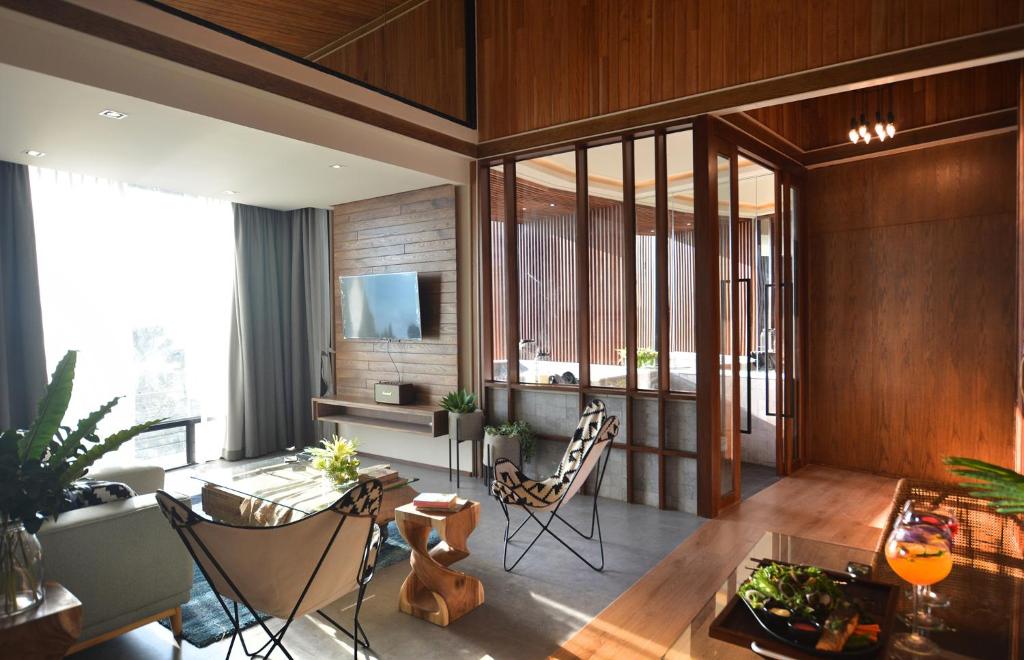 a living room with a table and chairs at The Cabin Beach Resort in Haad Rin