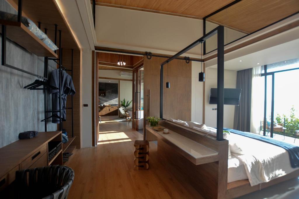 a bedroom with a large bed and a bathroom at The Cabin Beach Resort in Haad Rin