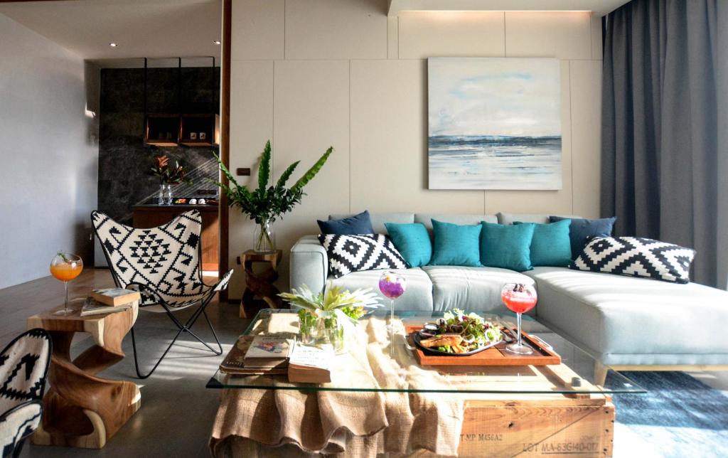 a living room with a couch and a table at The Cabin Beach Resort in Haad Rin