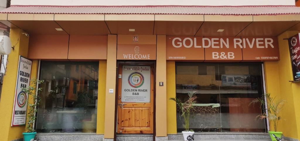 a store front with a golden river sign and a door at Golden River in Varanasi