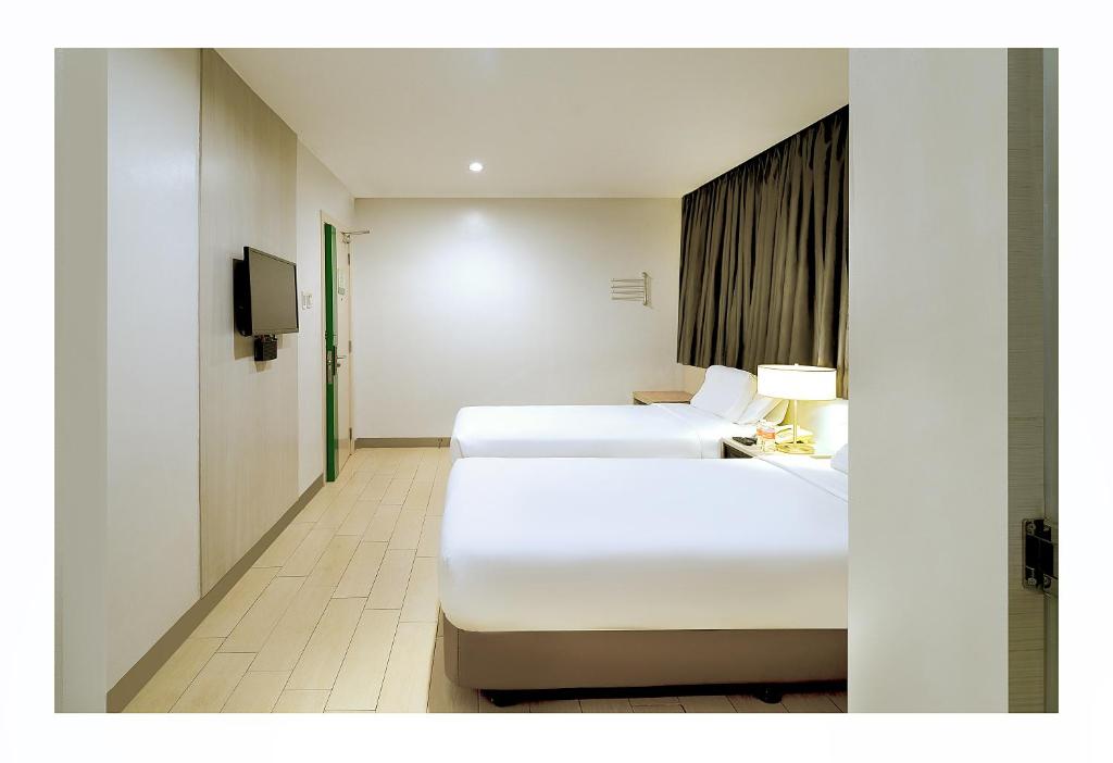 Postel nebo postele na pokoji v ubytování Go Hotels Ortigas Center