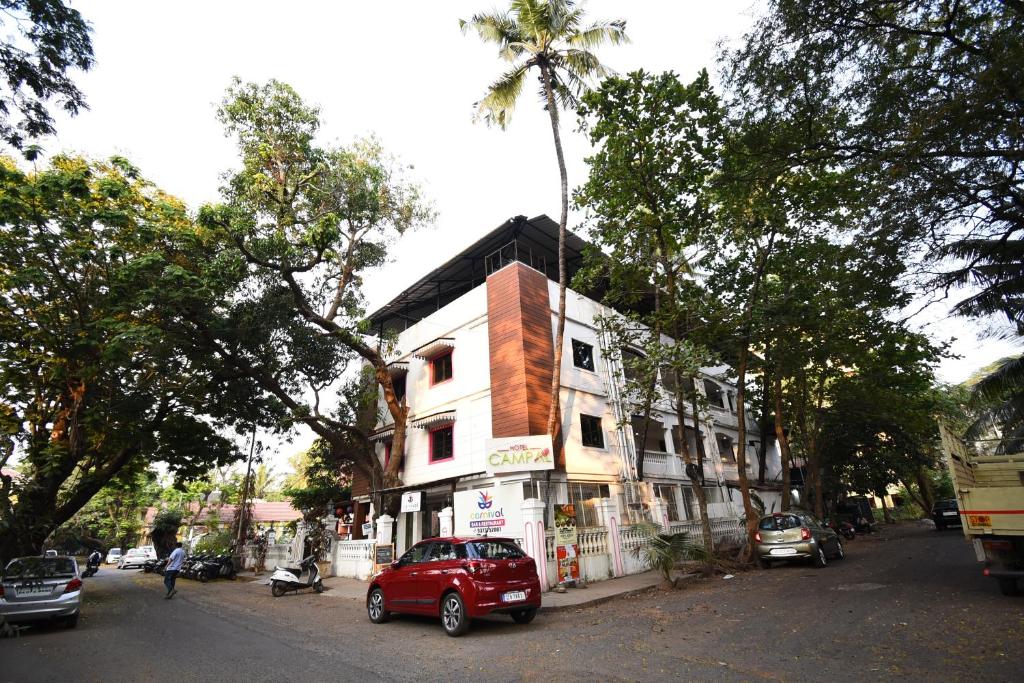 a red car parked in front of a building at Hotel Campal in Panaji