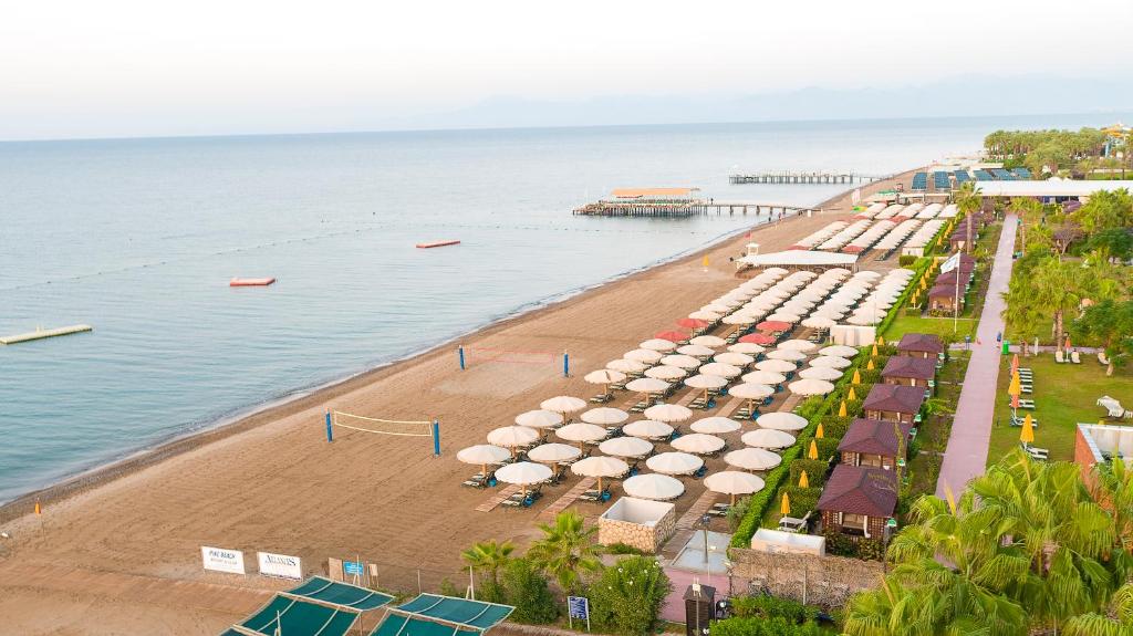 an aerial view of a beach with umbrellas at Pine Beach Belek in Belek