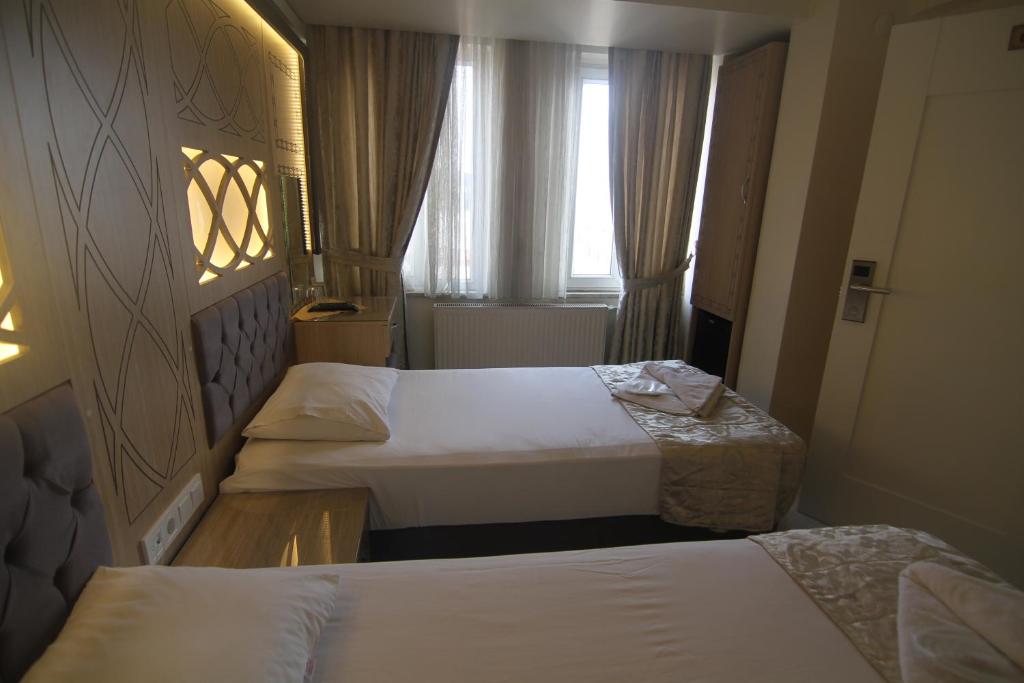 Postel nebo postele na pokoji v ubytování Grand Liza Hotel