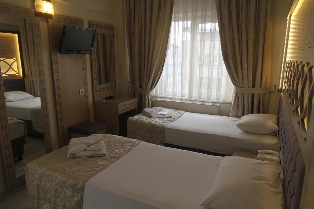 Postel nebo postele na pokoji v ubytování Grand Liza Hotel