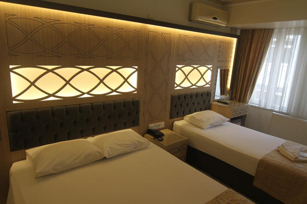 Postel nebo postele na pokoji v ubytování Grand Liza Hotel