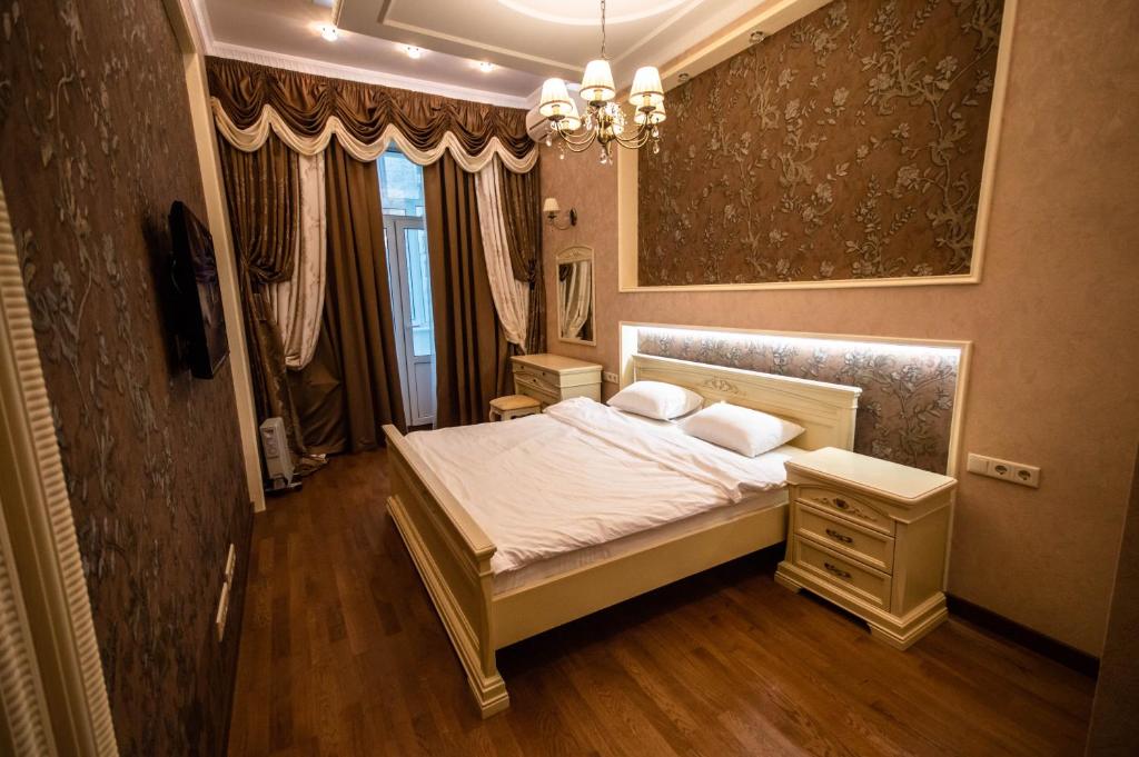 1 dormitorio con cama blanca y espejo en Kyiv 2Rooms Classic Apartment, en Kiev