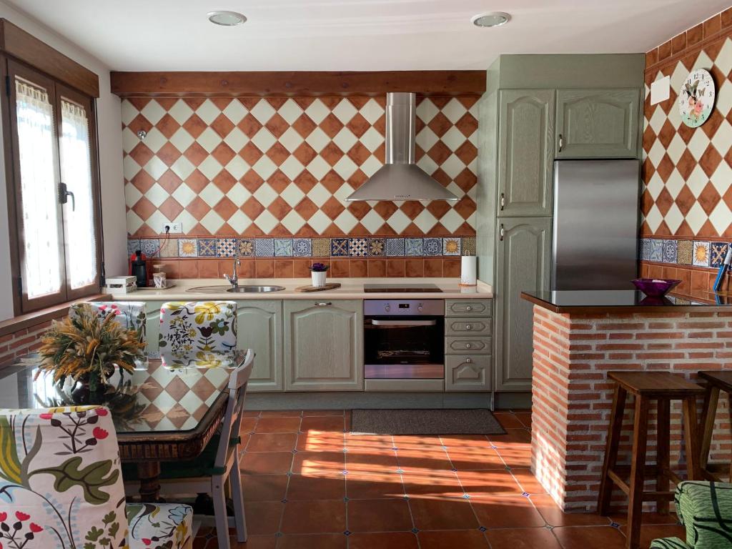 a kitchen with a sink and a stove at La Casa De La Abuela in Ortigosa del Monte