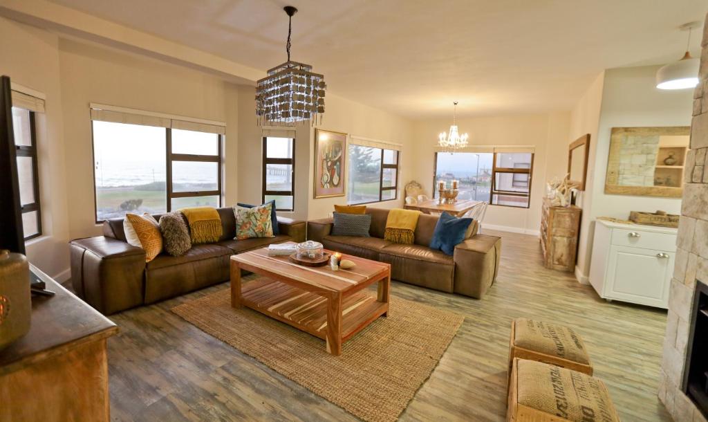a living room with a couch and a table at Beachfront Apartment @ Morleenpark unit 11 in Swakopmund