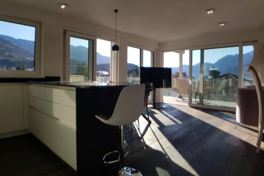 a kitchen with a bar with a white chair in it at Gardenpark Loft in Auer