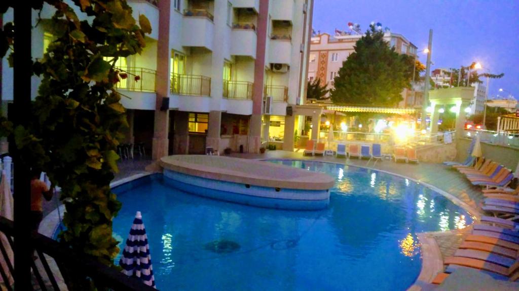 a large swimming pool in front of a building at meryemana hotel in Didim
