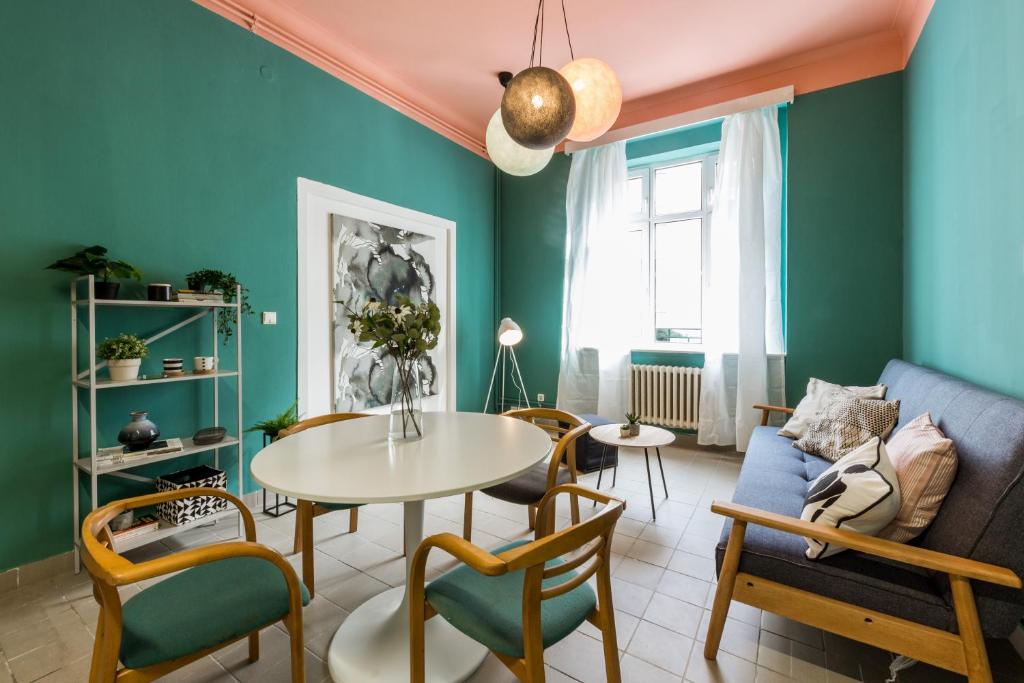 a living room with a table and chairs and a couch at Apartment Jeseniova in Prague