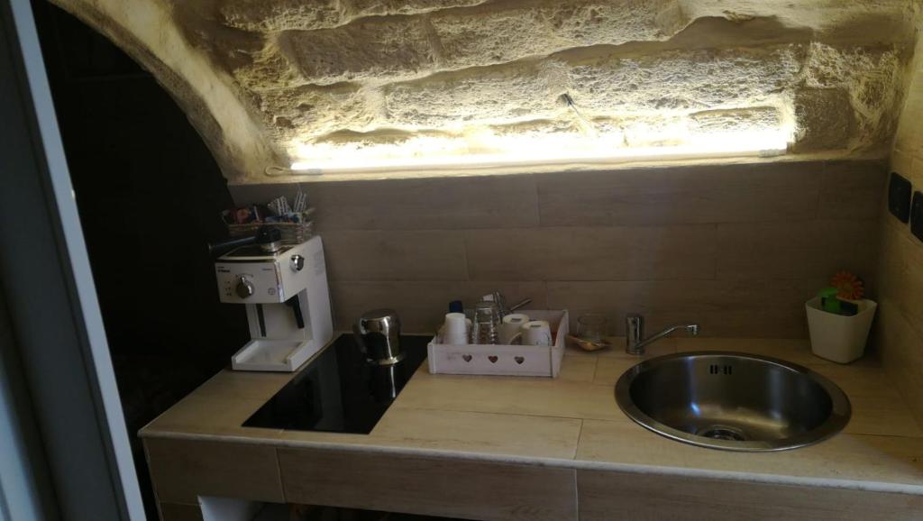 a bathroom with a sink and a microscope on a counter at Il sottano borgo antico in Bari