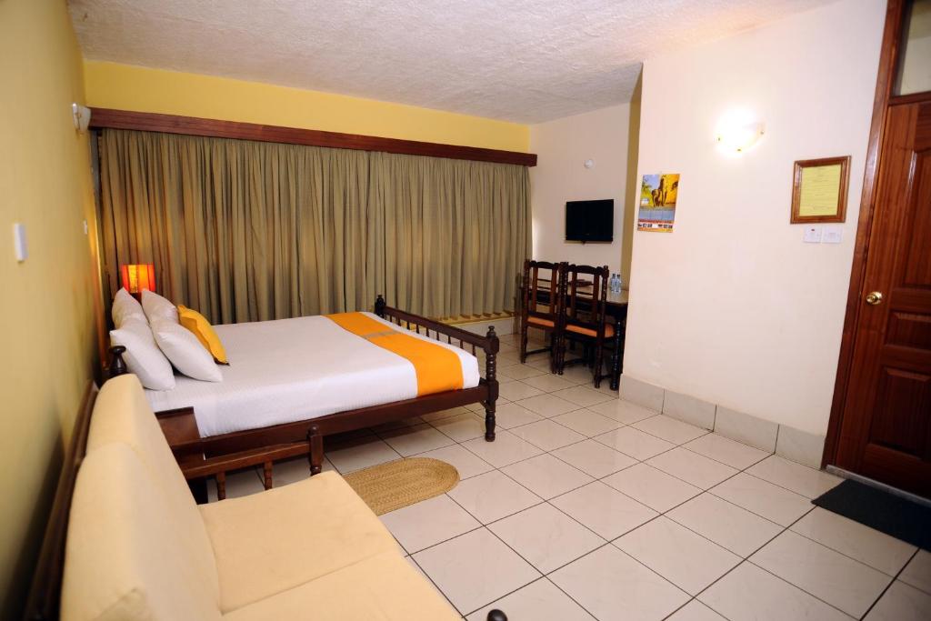 Postel nebo postele na pokoji v ubytování Kenya Comfort Suites