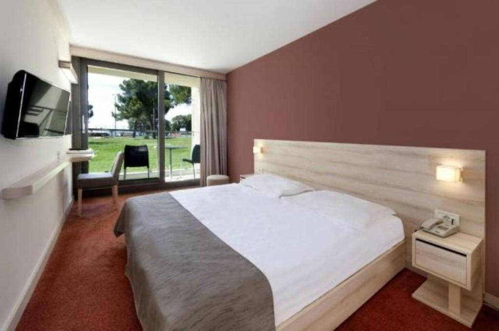 Postel nebo postele na pokoji v ubytování Hotel Materada Plava Laguna
