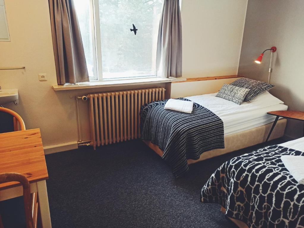 Llit o llits en una habitació de Hotel Hjardarbol