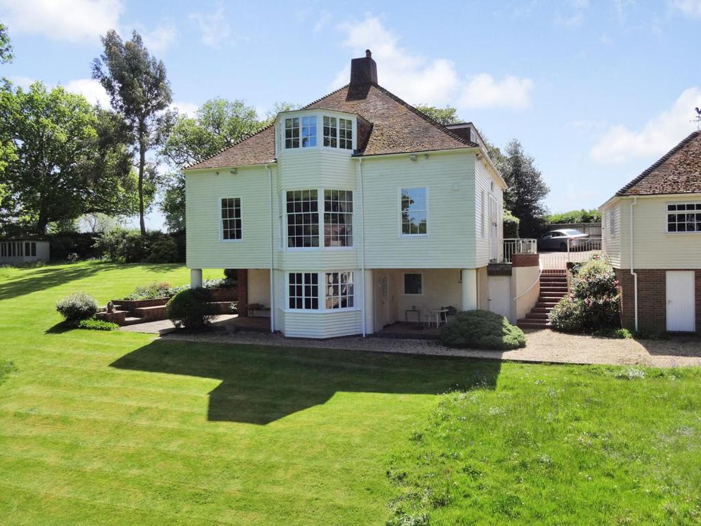 a large white house with a grass yard at Walkers Countryside Retreat in Rotherfield Peppard