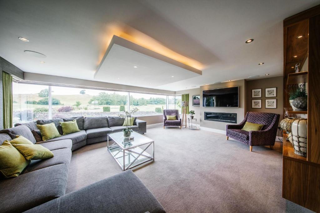 a living room with a couch and a table at Carus House @ Carus Green in Kendal