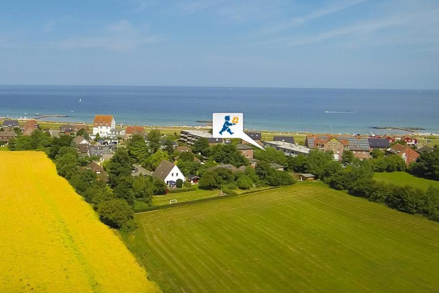 a large sign on top of a house with a green field at Zuflucht in Schönberger Strand