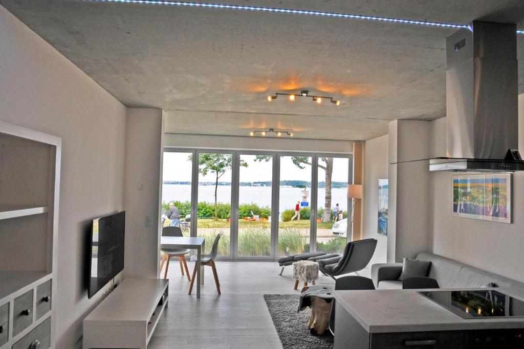 a living room with a view of the ocean at Duenengras in Heikendorf
