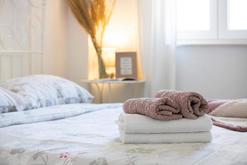 a couple of towels sitting on top of a bed at Dida moj in Senj