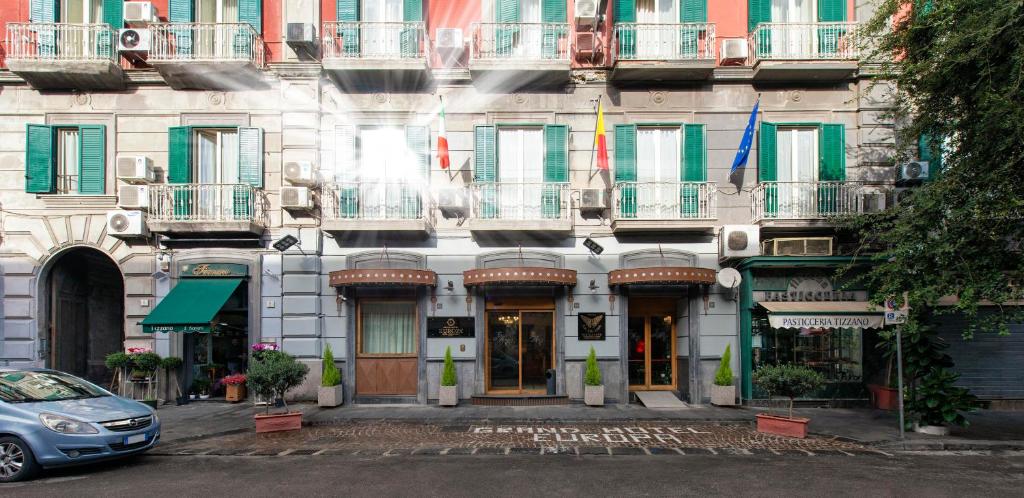 a building with flags on the front of it at Grand Hotel Europa & Restaurant in Naples