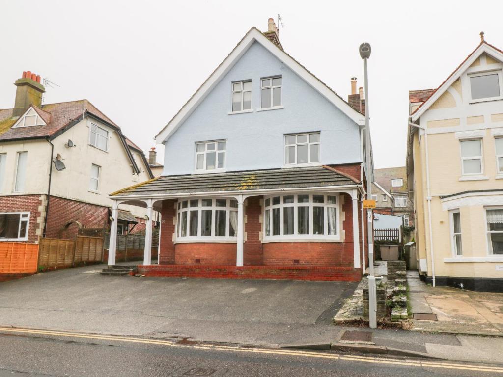 a white and red house on the side of a street at 20 Ulwell Road in Swanage