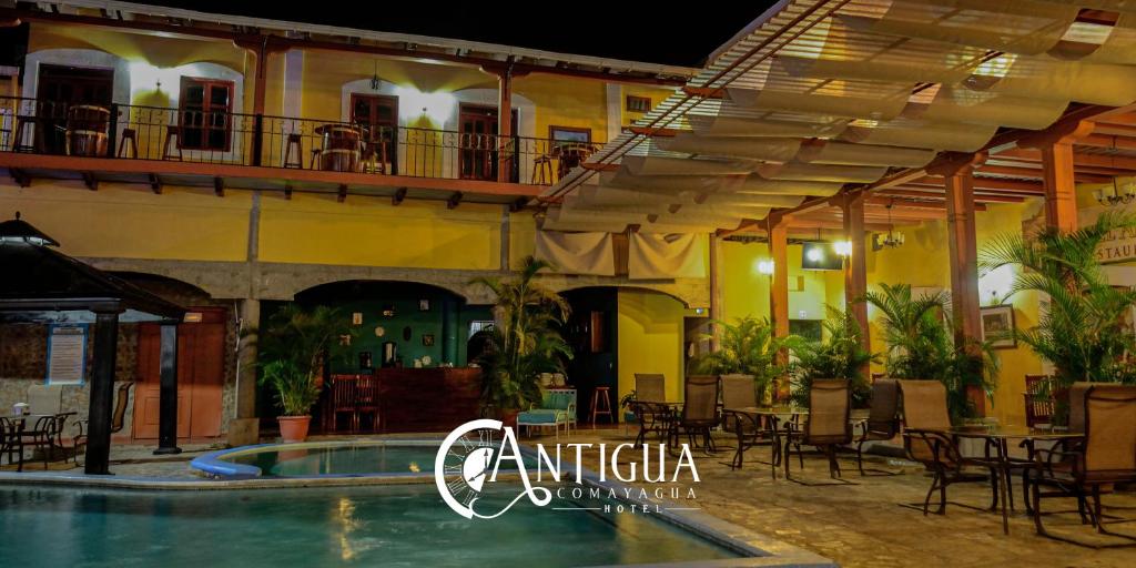 a hotel with a swimming pool in front of a building at Hotel Antigua Comayagua in Comayagua