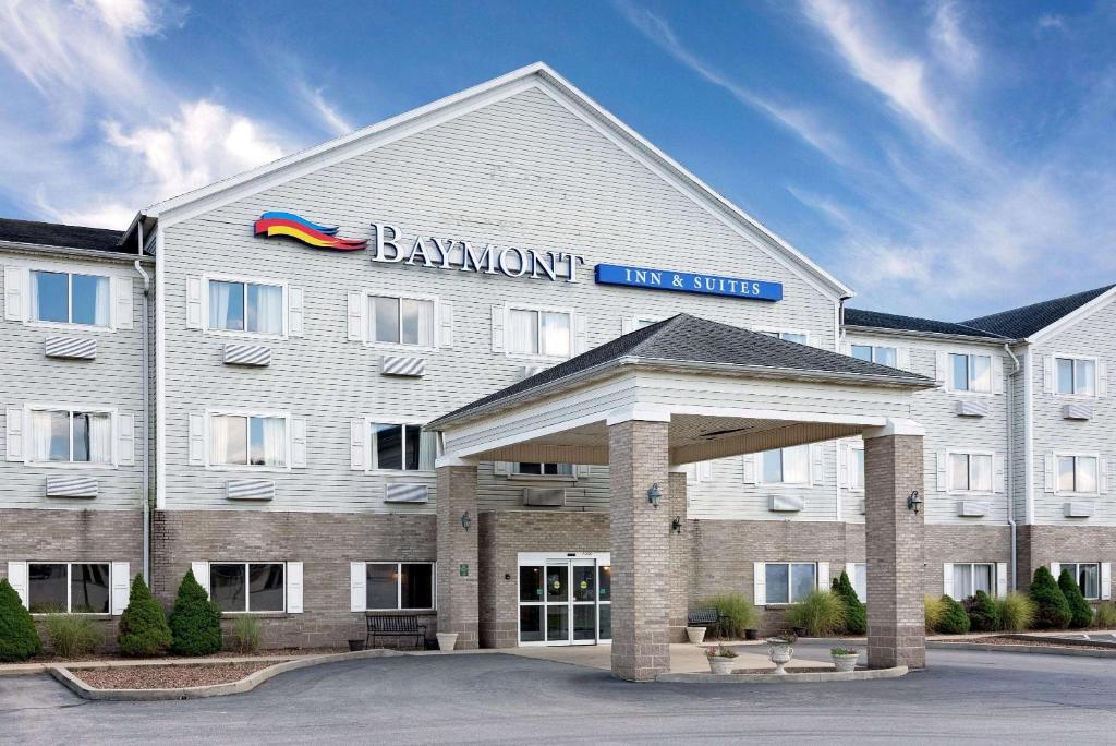 a large white building with a sign on it at Baymont by Wyndham Lawrenceburg in Lawrenceburg