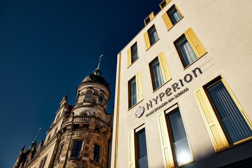 a building with a clock tower on top of it at HYPERION Hotel Dresden Am Schloss in Dresden